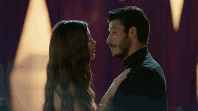 a man and woman are looking into each others eyes