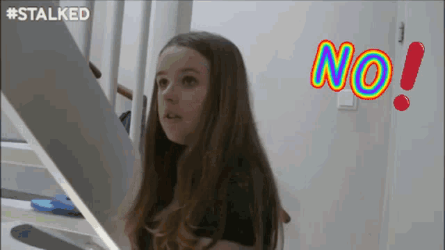 a girl is standing on a set of stairs with the word no written in the corner