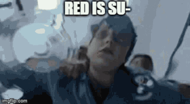 a man is holding another man 's neck and says red is su-