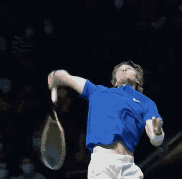 a tennis player wearing a headband and a blue shirt