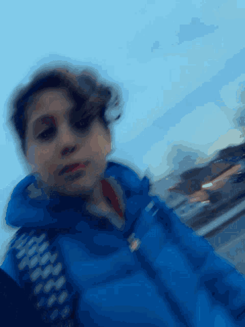 a blurry picture of a young boy in a blue jacket