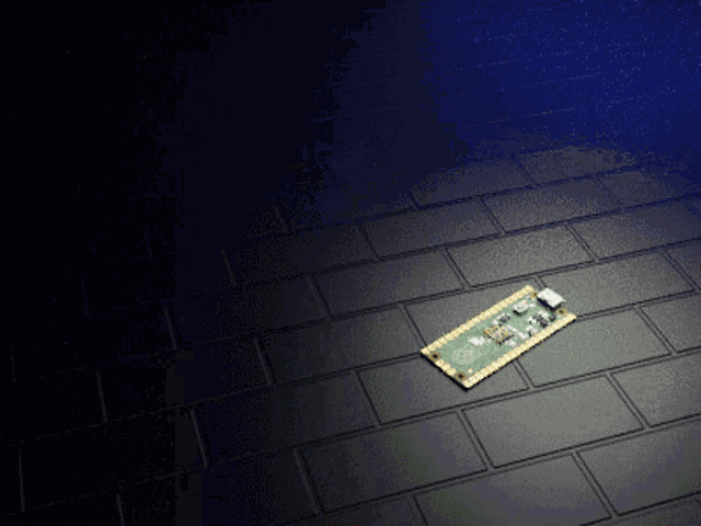 a piece of electronic equipment is laying on a black tile floor