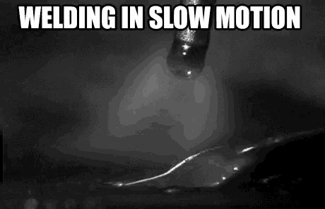 a black and white photo of a needle welding a piece of metal in slow motion .