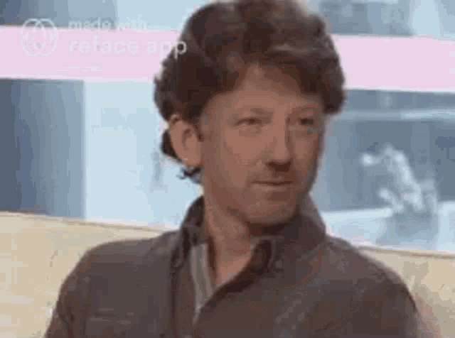 a man is sitting on a couch with his eyes closed and looking at the camera .