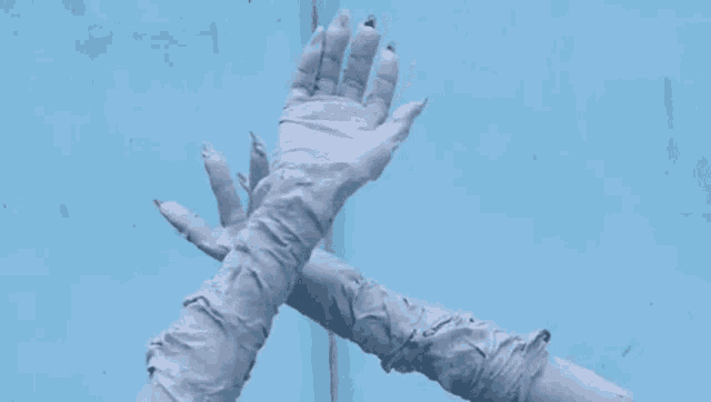 a person 's hands are painted white and wrapped in bandages .