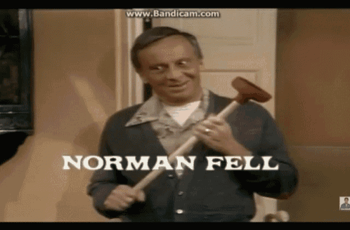 a man holding a plunger with the name norman fell on it