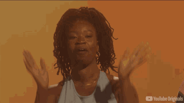 a woman with her arms outstretched is on a youtube originals ad