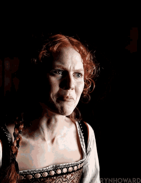 a woman with red hair is making a funny face and the name howard is on the bottom