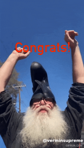a man with a beard is wearing a helmet and holding up his arms with the word congrats in red