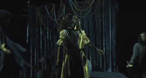 a group of people are standing in a dark room
