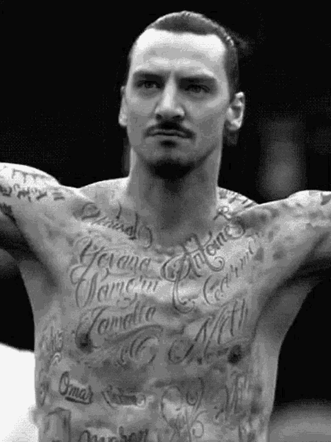 a man with a lot of tattoos on his chest including one that says omar
