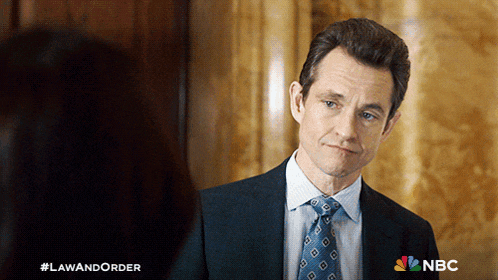a man in a suit and tie is looking at a woman in a law and order ad