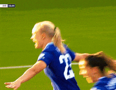 a female soccer player in a blue jersey with the number 23 on it
