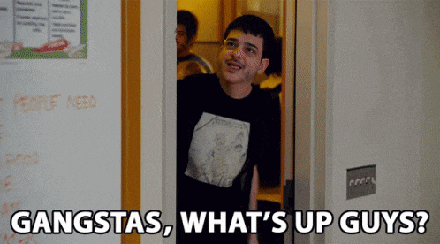 a man standing in a doorway with the words gangstas what 's up guys on the bottom