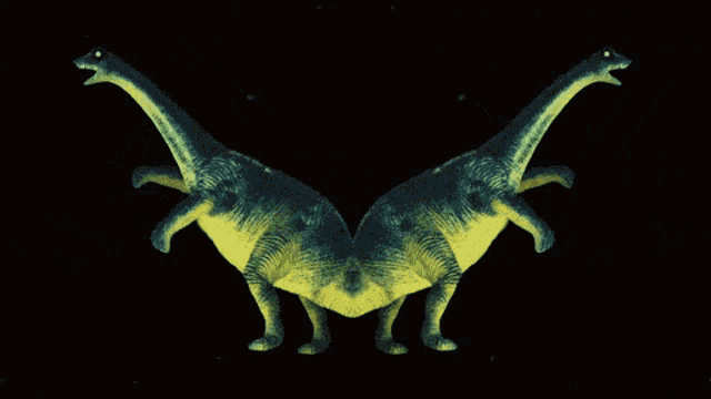 two green and yellow dinosaurs standing next to each other on a black background