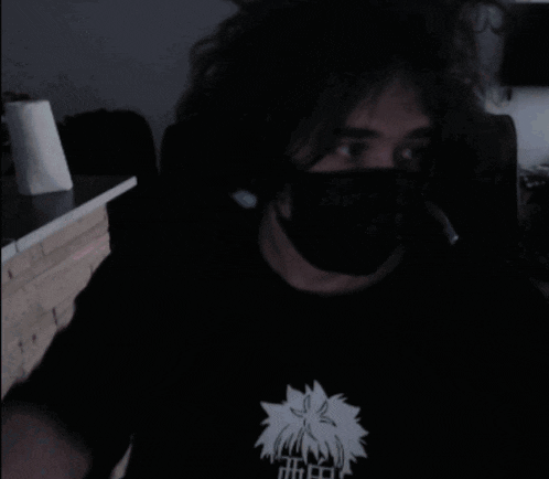 a man wearing a face mask is giving a thumbs up .