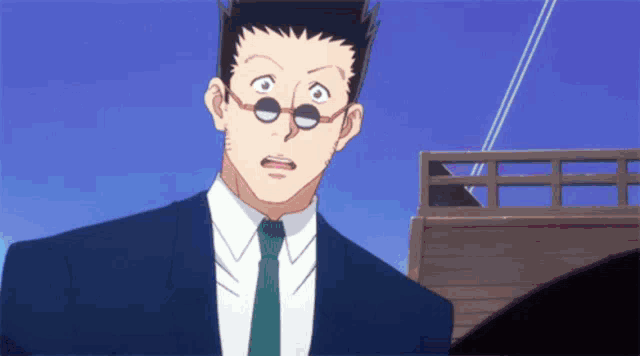 a man in a suit and tie is looking at something