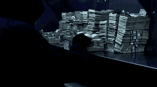 a stack of money on a table with a blue ribbon that says ' united states of america ' on it