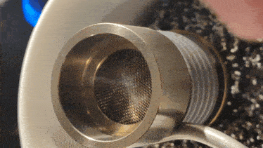 a close up of a metal object with a strainer on it
