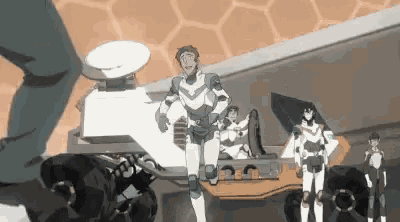 a group of robots are standing next to each other in a room in a video game .