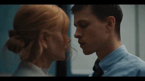 a man and a woman are looking at each other