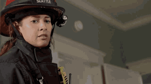 a woman wearing a helmet with seattle on it