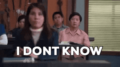 a woman is sitting in a classroom with a group of people and says `` i don t know '' .