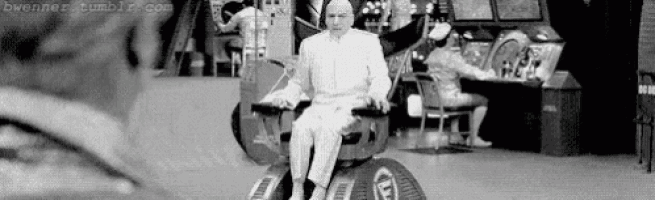 a black and white photo of a man sitting in a chair in an arcade .