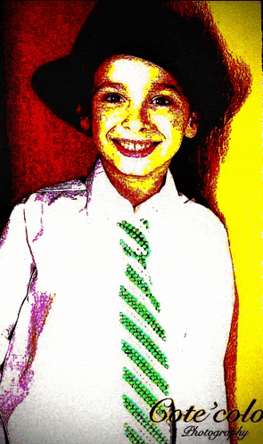 a young boy wearing a hat and tie is photographed by arte colo photography