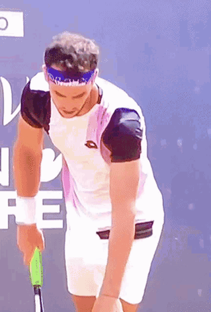 a man wearing a headband and holding a tennis racquet