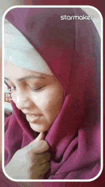 a woman wearing a purple hijab and a white head scarf has a tiktok video on her face