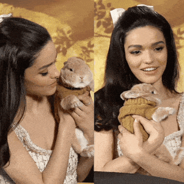 a woman is holding a small rabbit in her arms
