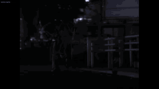 a dark street at night with a few lights visible
