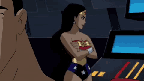 a woman in a wonder woman costume is standing next to a man