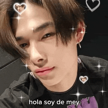 a close up of a person 's face with hearts on it and the words `` hola soy de me '' .