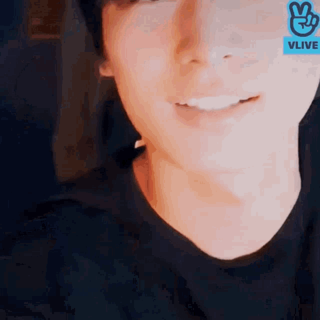 a close up of a person 's face with a vlive sticker on his forehead .