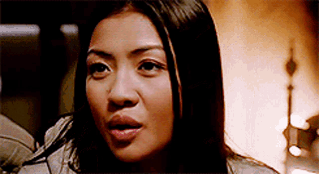 a close up of a woman 's face looking at the camera