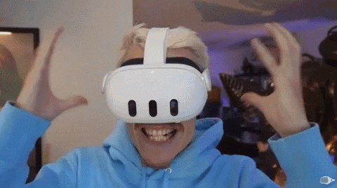 a man is wearing a virtual reality headset and smiling