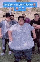a group of men are posing for a picture and one of them has a flopcoin mod meetup sticker on his shirt