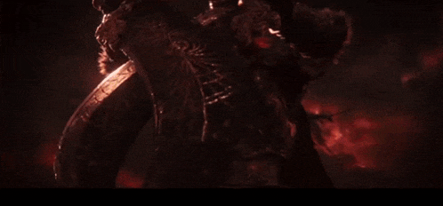a large demon with horns is flying through the air in a dark room .