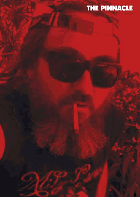 a man with a beard wearing sunglasses smoking a cigarette and the words u wot mate on the bottom