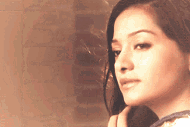 a close up of a woman 's face looking at the camera