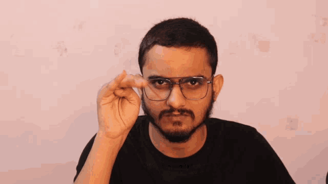 a man wearing glasses and a black shirt