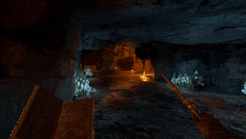 a person holding a sword in a cave with flowers