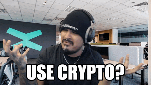 a man wearing headphones says " use crypto " in an office