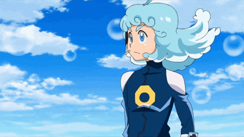 a cartoon character with blue hair and a circle on his chest stands in front of a blue sky