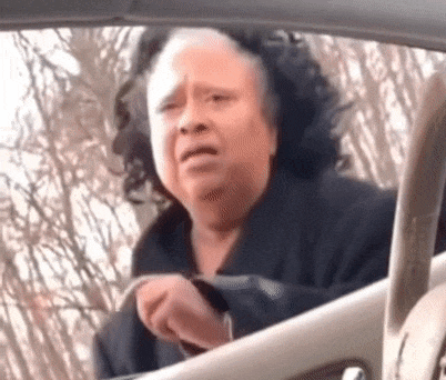 a woman is sitting in the driver 's seat of a car .