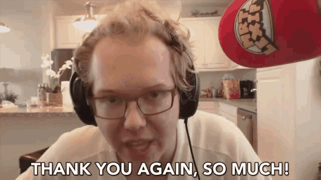 a man wearing headphones and glasses is saying thank you again so much