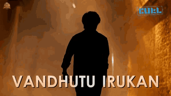 a silhouette of a man standing in a dark tunnel with the words vandhutu irukan below him