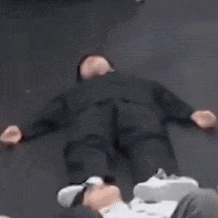 a blurry picture of a man laying on the floor with his arms outstretched .